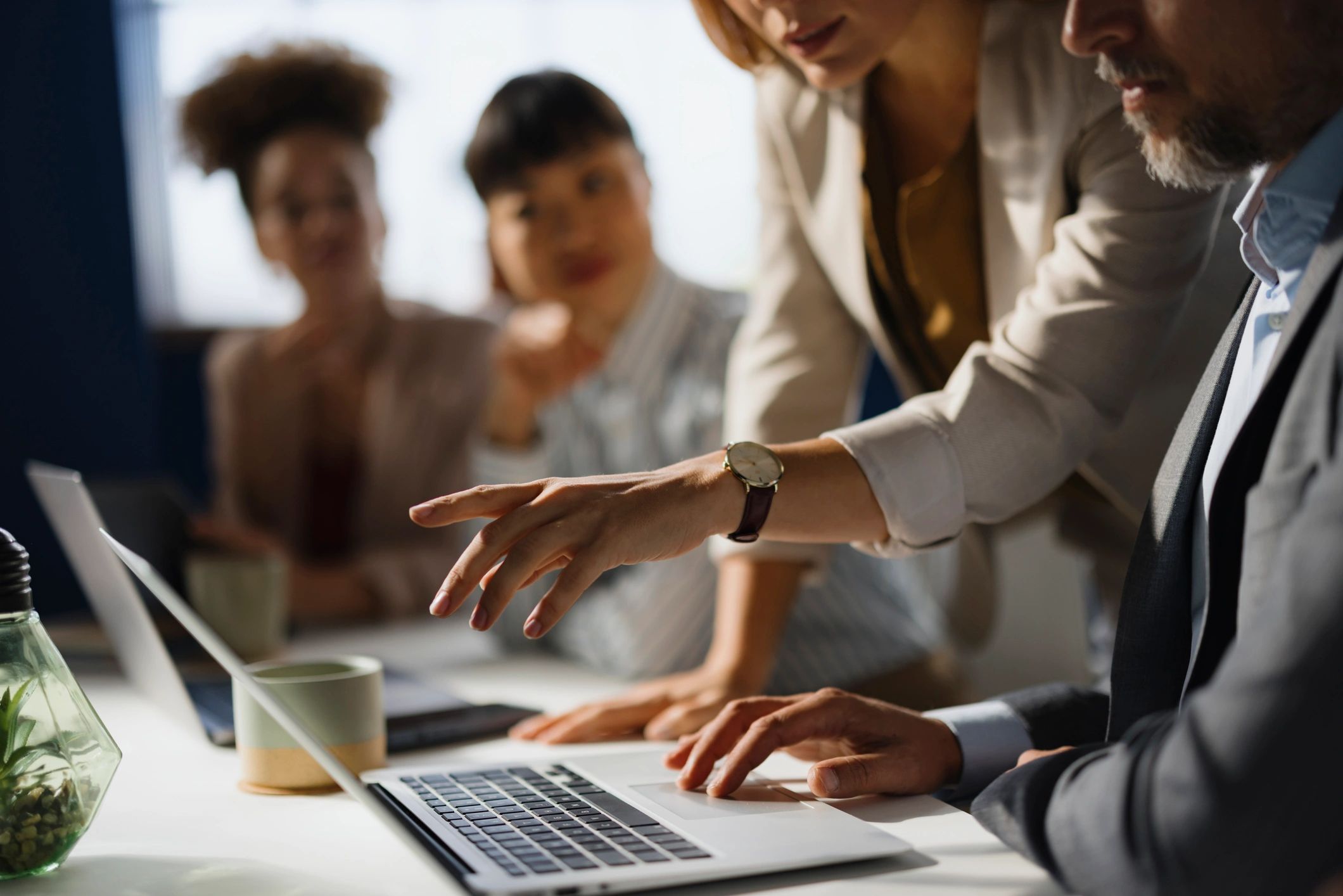 Team reviewing social media performance on a laptop in an office